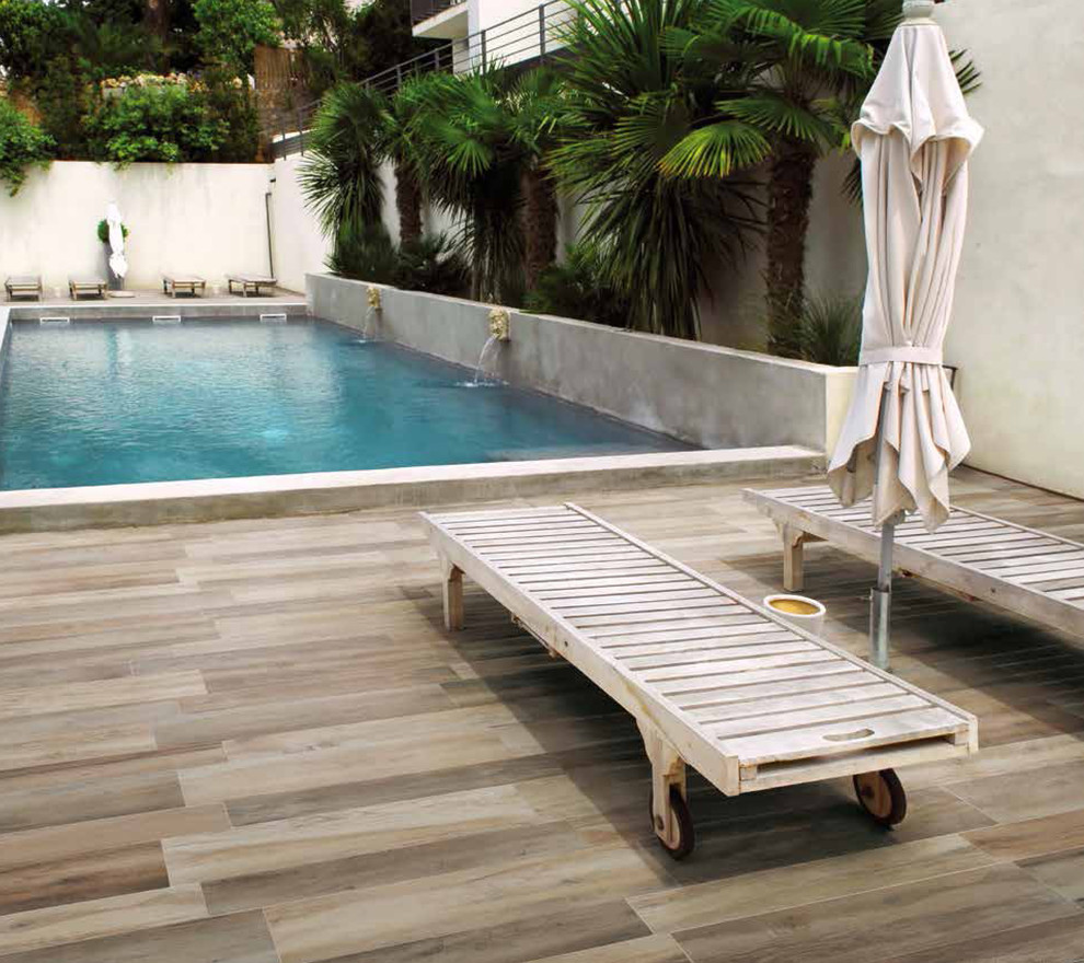 Mittelgroßer, Gefliester Moderner Pool hinter dem Haus in rechteckiger Form mit Wasserspiel in Miami