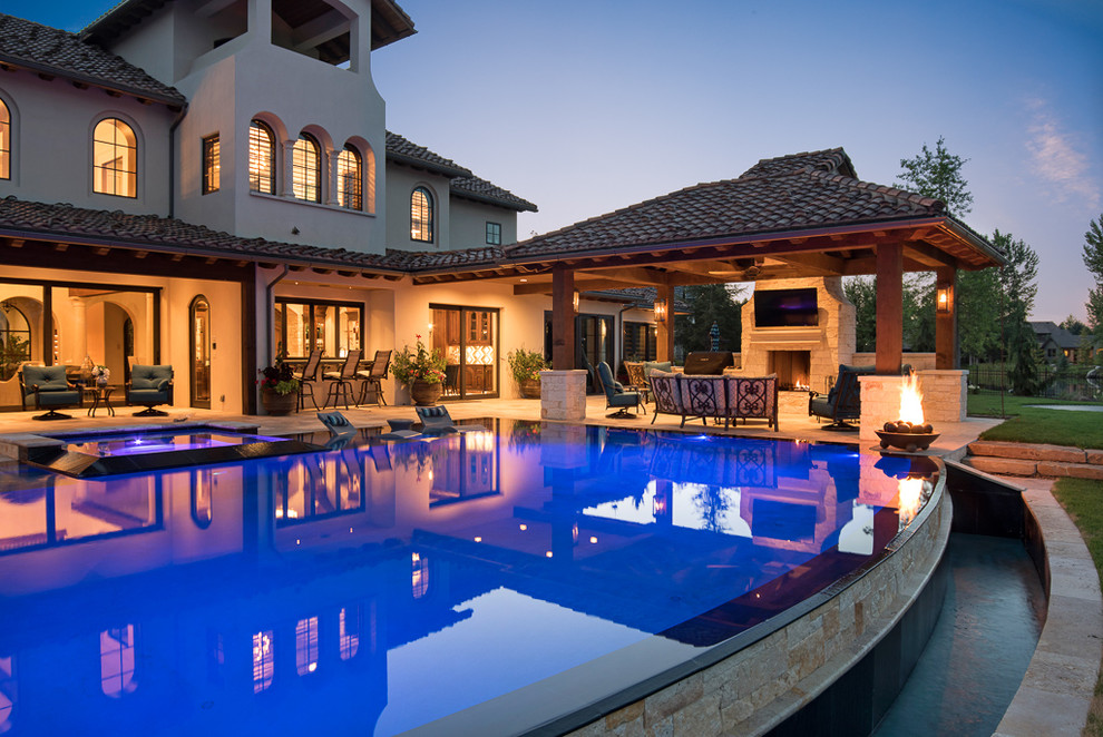Ispirazione per una grande piscina a sfioro infinito mediterranea personalizzata dietro casa con una vasca idromassaggio e pavimentazioni in pietra naturale