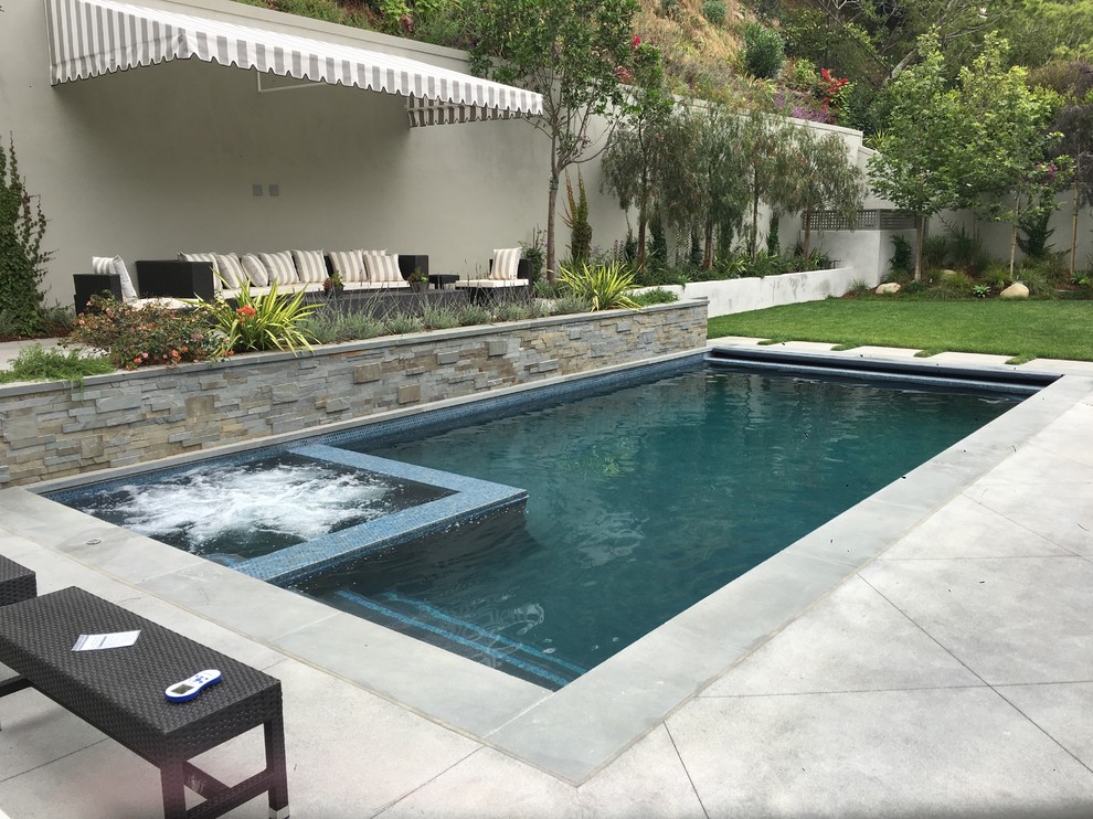 This is an example of a medium sized classic back rectangular lengths swimming pool in Los Angeles with tiled flooring.