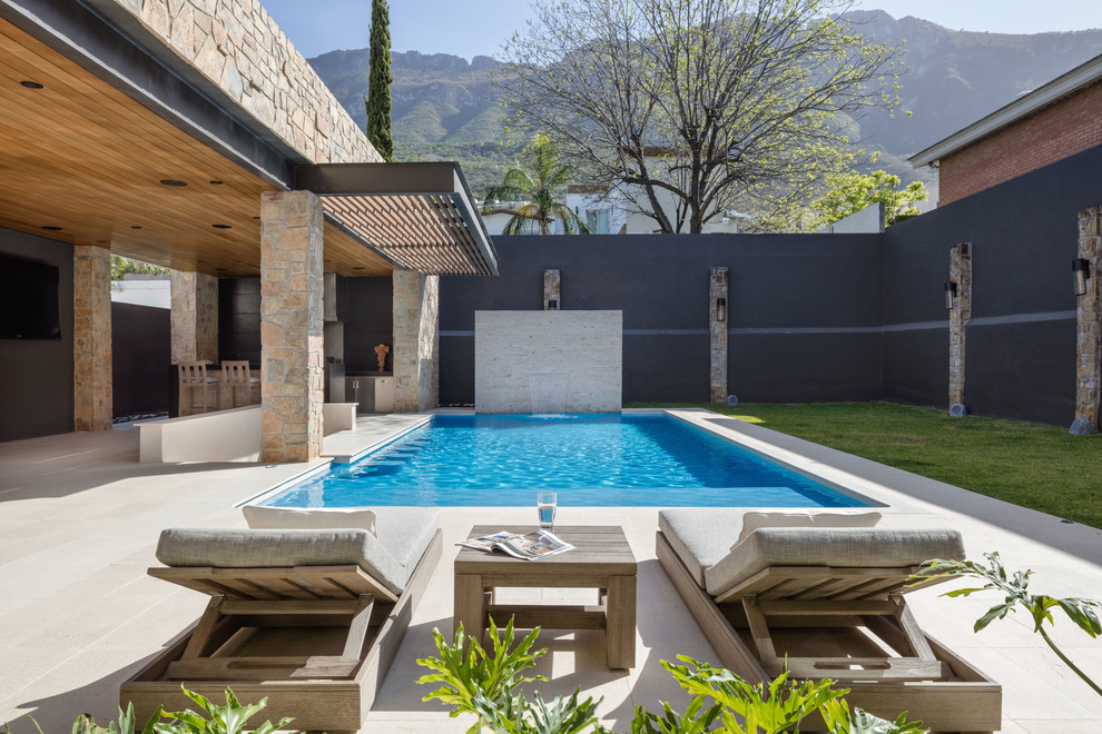 Example of a trendy backyard rectangular pool design