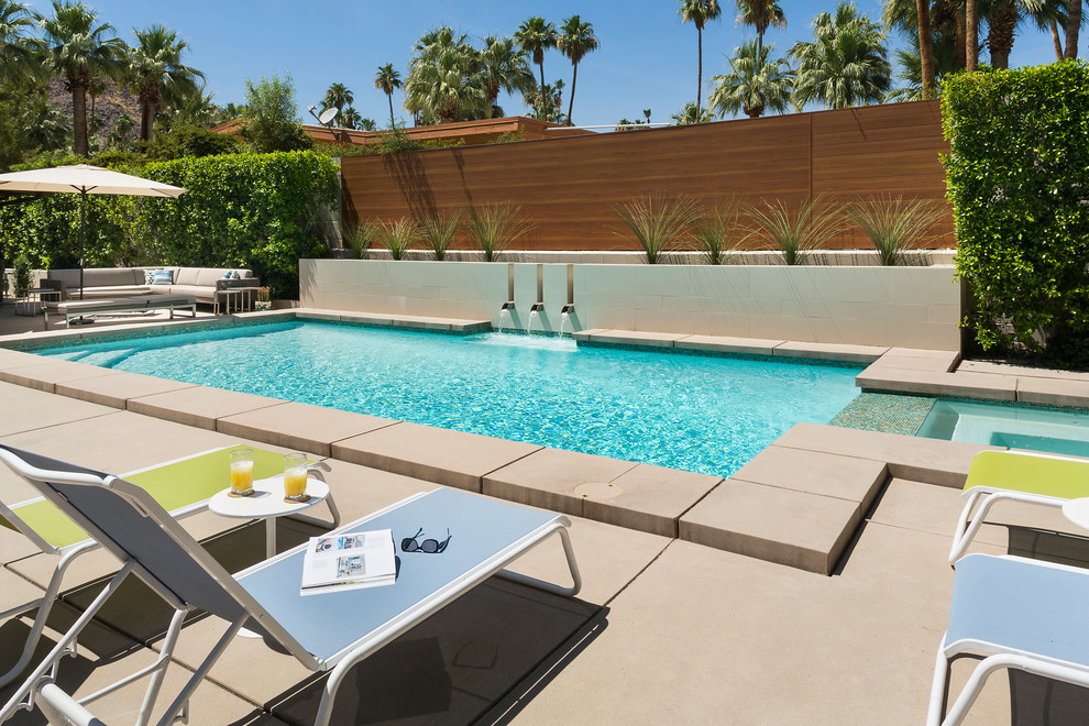 Trendy backyard concrete and rectangular pool fountain photo in Los Angeles
