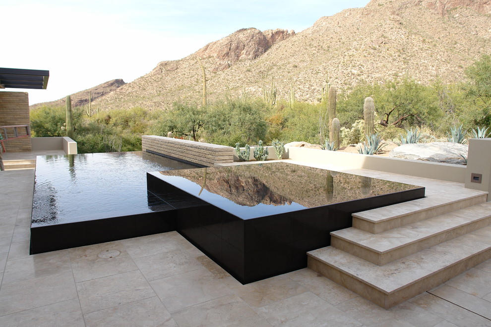 This is an example of a contemporary infinity swimming pool in Phoenix.