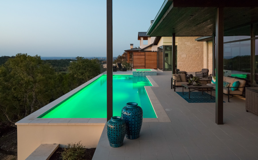 Mittelgroßer, Gefliester Moderner Pool hinter dem Haus in rechteckiger Form in Austin