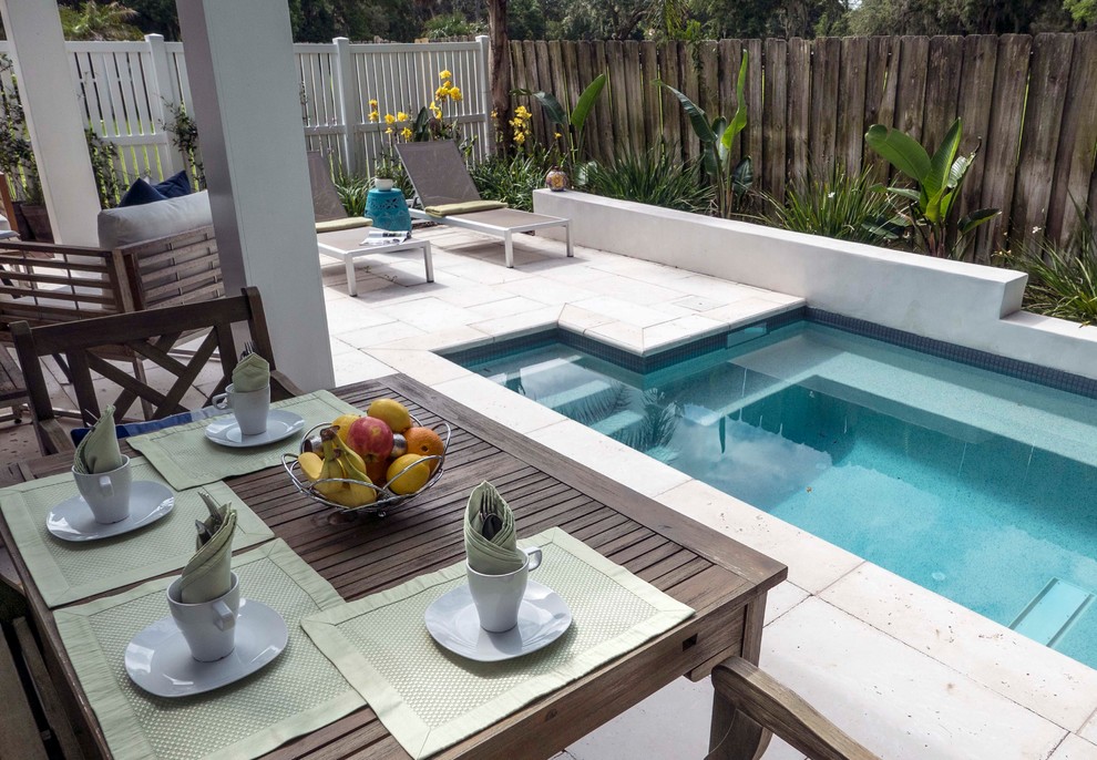 Small contemporary back custom shaped swimming pool in Jacksonville with concrete paving.