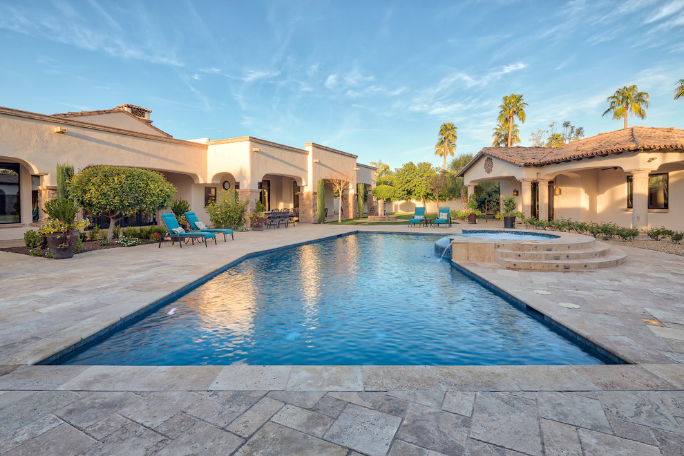 Photo of a large contemporary back custom shaped swimming pool in Phoenix with concrete paving.