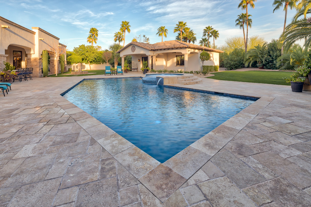 Example of a large trendy backyard concrete paver and custom-shaped pool design in Phoenix