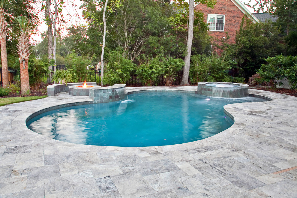 Immagine di una grande piscina chic personalizzata dietro casa con una vasca idromassaggio