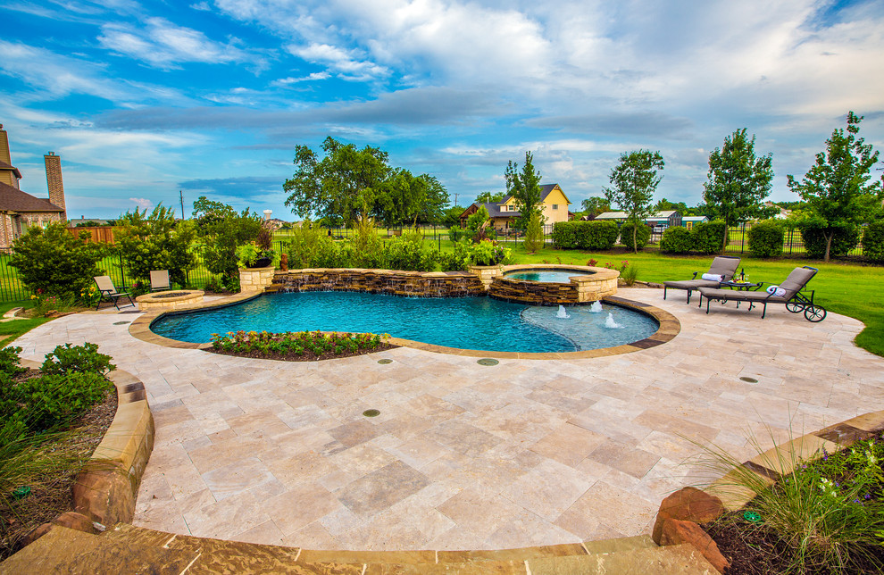 Example of a mid-sized classic backyard stone and custom-shaped natural hot tub design in Dallas