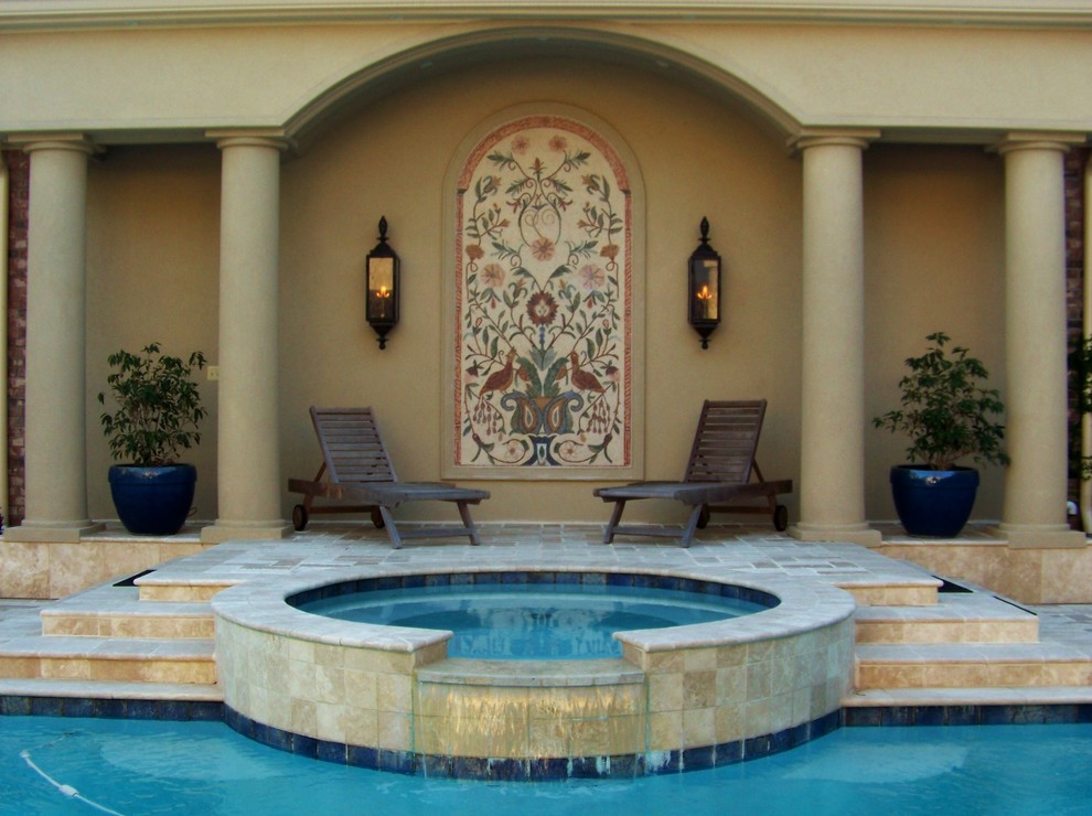 Design ideas for an expansive mediterranean back custom shaped swimming pool in New Orleans with a water feature and natural stone paving.