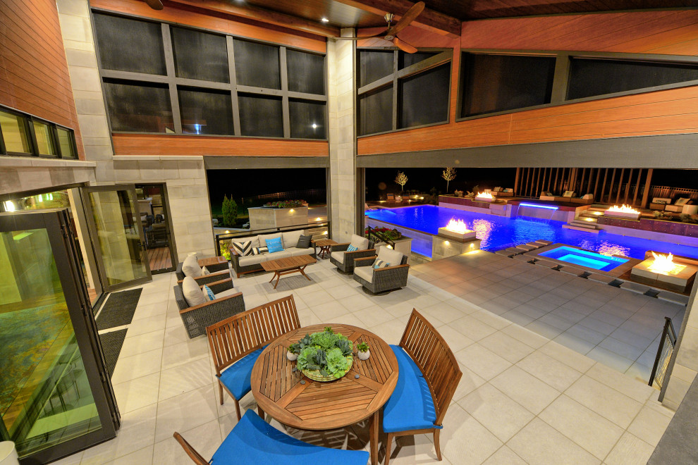 Пример оригинального дизайна: огромный прямоугольный бассейн на заднем дворе в стиле модернизм с джакузи и покрытием из плитки