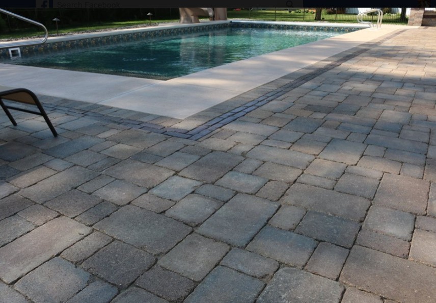 Idées déco pour une grande piscine arrière classique rectangle avec des pavés en béton.