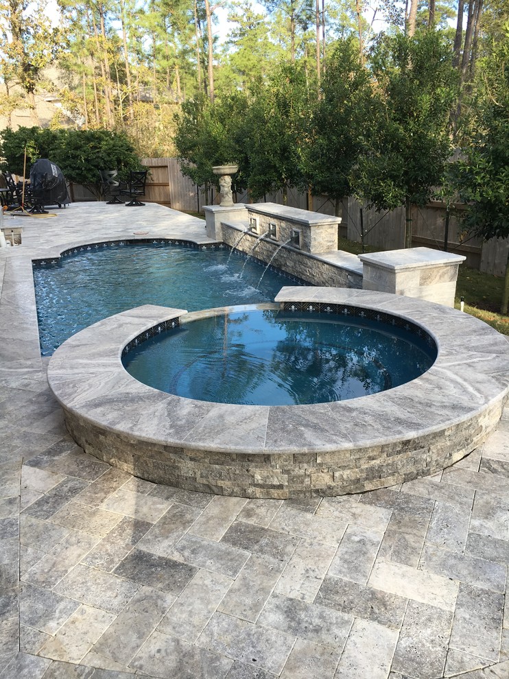 Mid-sized transitional backyard concrete paver and custom-shaped hot tub photo in Houston