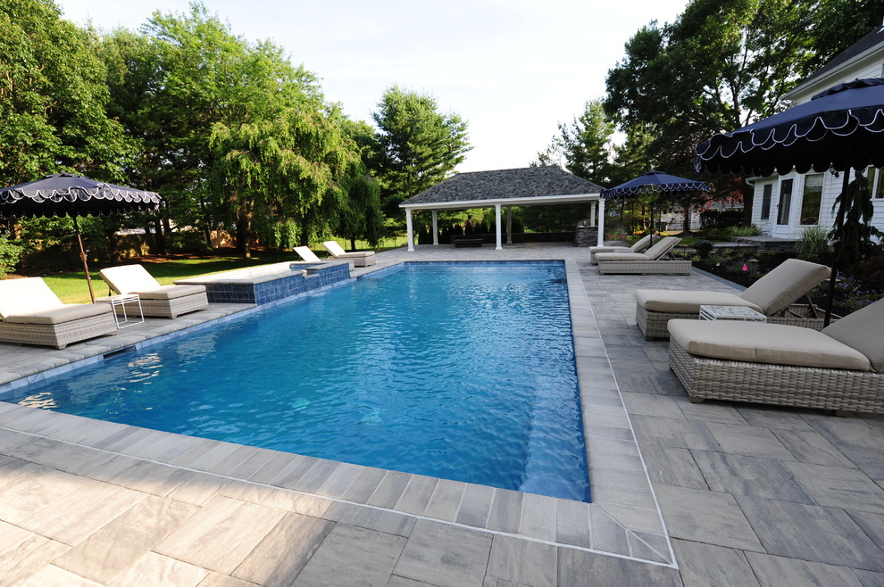 Идея дизайна: большой спортивный, прямоугольный бассейн на заднем дворе в классическом стиле с джакузи и покрытием из каменной брусчатки