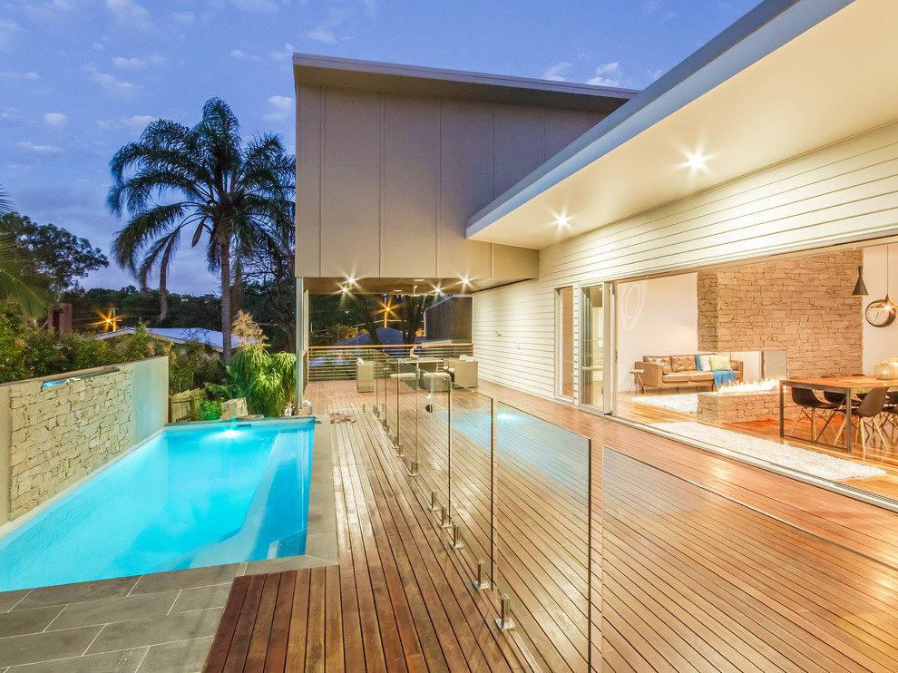 Medium sized contemporary back rectangular lengths swimming pool in Brisbane with decking.