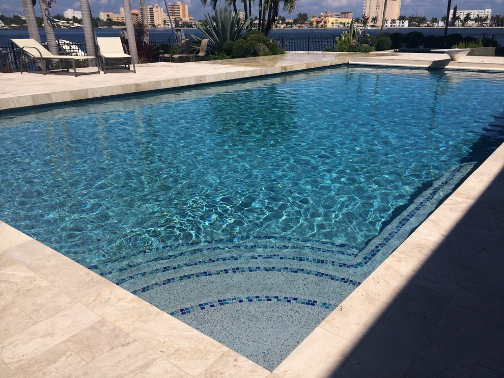 Example of a large transitional backyard rectangular and tile lap pool design in Miami