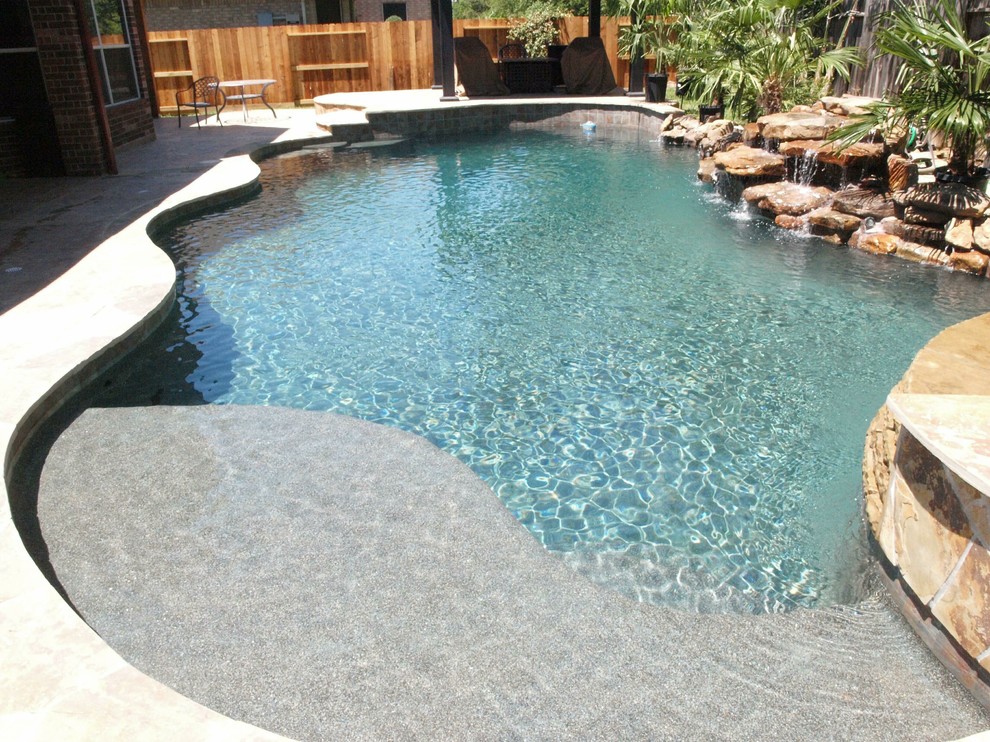 Hot tub - large contemporary backyard stamped concrete and custom-shaped hot tub idea in Houston