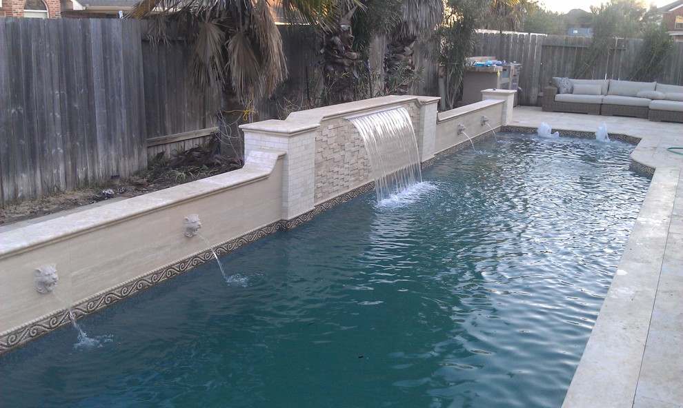 Inspiration for a mid-sized contemporary backyard stone and rectangular lap pool fountain remodel in Houston
