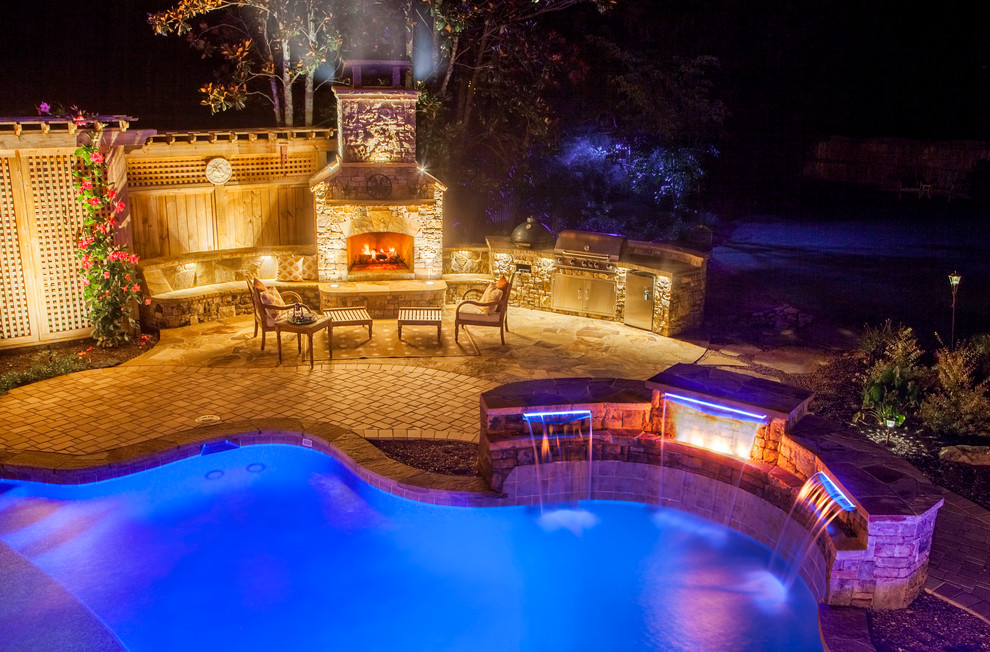 Inspiration for a mid-sized contemporary backyard stone and custom-shaped lap hot tub remodel in Atlanta