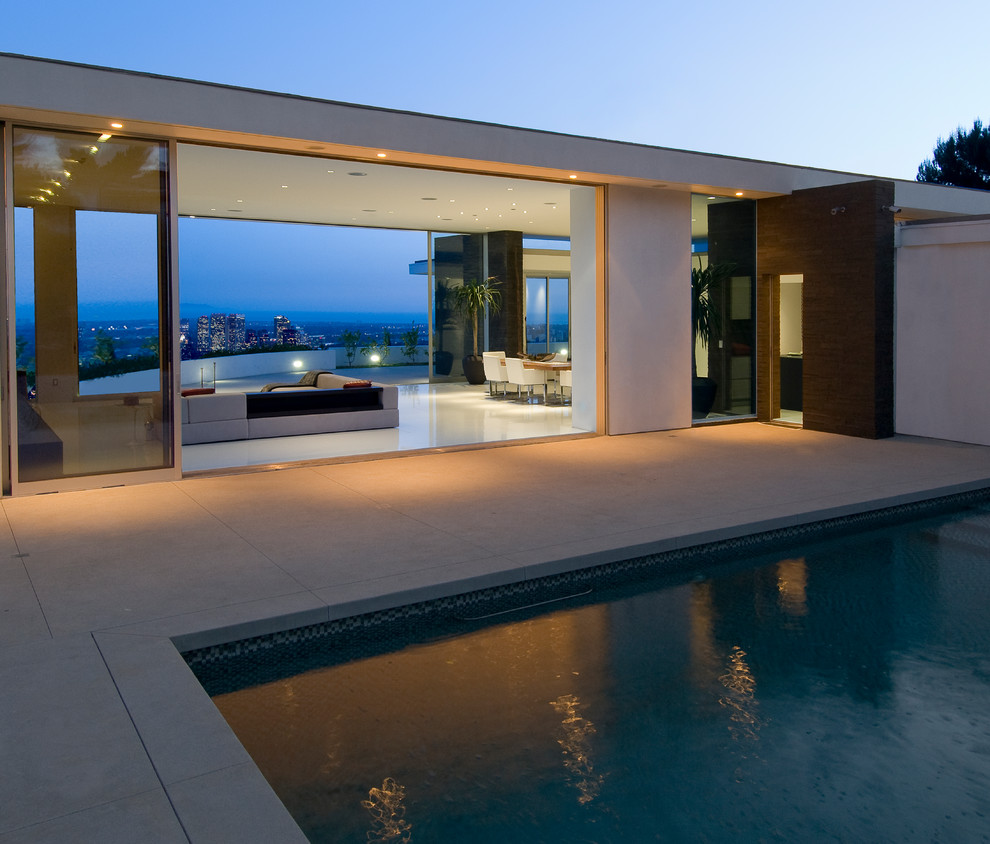 Inspiration for a medium sized contemporary rectangular lengths swimming pool in Los Angeles with concrete paving.