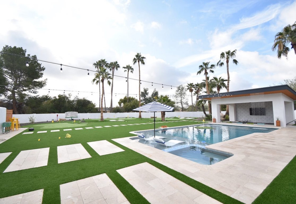 Pool - large traditional backyard stone and custom-shaped pool idea in Phoenix