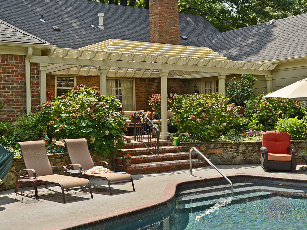 На фото: большой бассейн на заднем дворе в классическом стиле с фонтаном и мощением клинкерной брусчаткой с