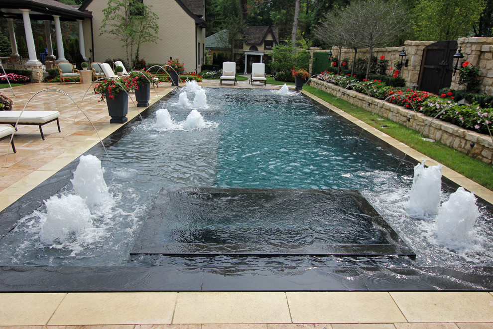 Example of a large trendy courtyard rectangular pool fountain design in Chicago