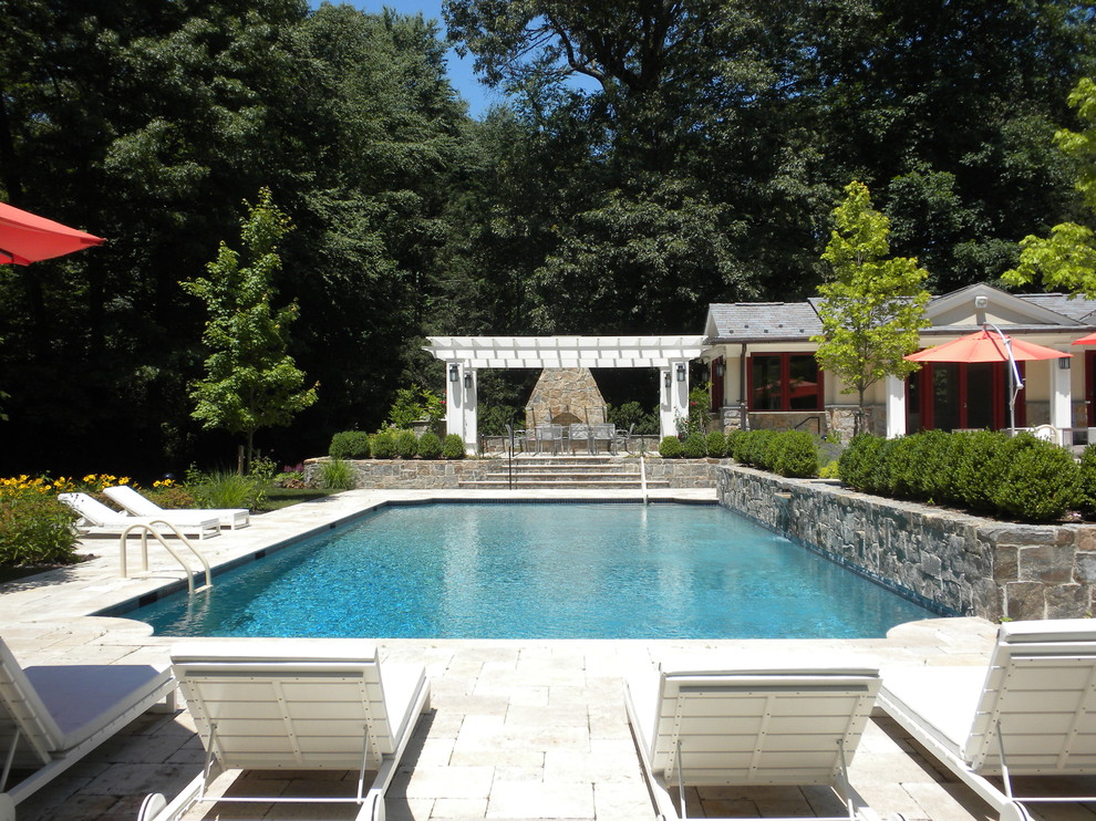 Diseño de piscinas y jacuzzis alargados de estilo americano grandes rectangulares en patio trasero con adoquines de piedra natural