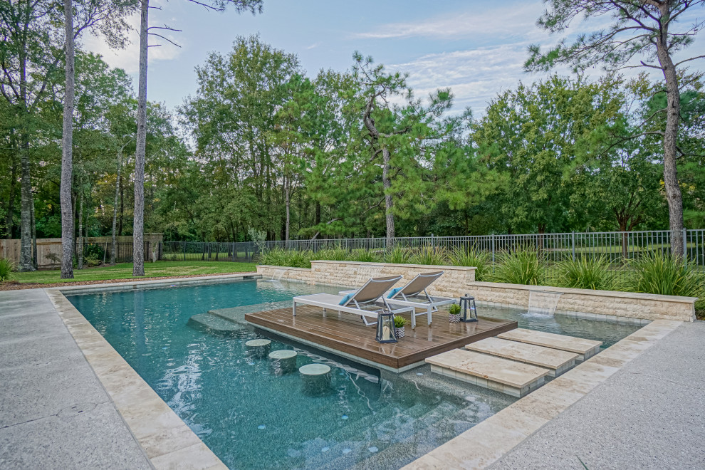 Large midcentury back rectangular swimming pool in Houston with decking.