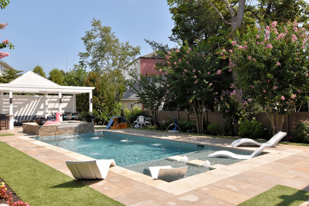 Ispirazione per una piscina design rettangolare di medie dimensioni e dietro casa con fontane e pavimentazioni in pietra naturale