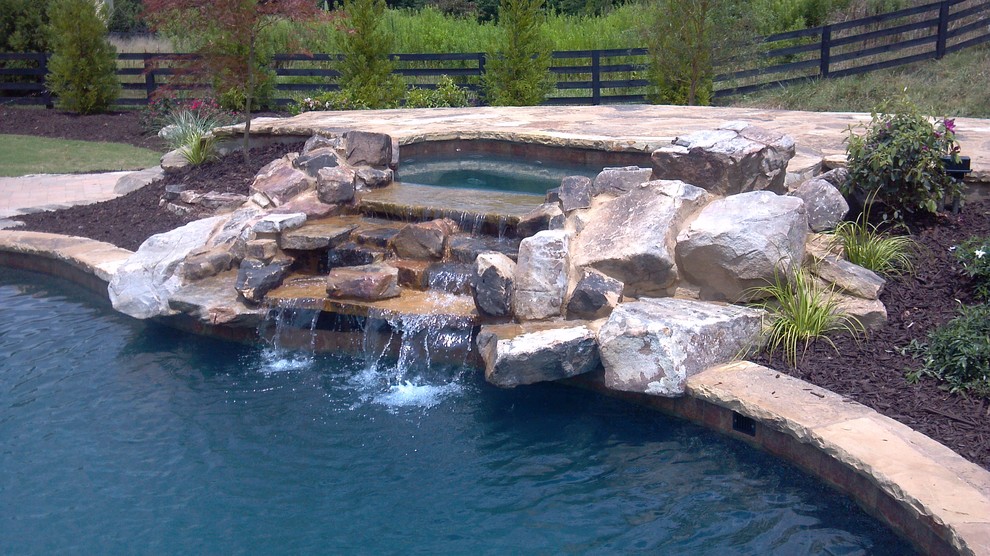 Hot tub - large traditional backyard stone and custom-shaped natural hot tub idea in Atlanta
