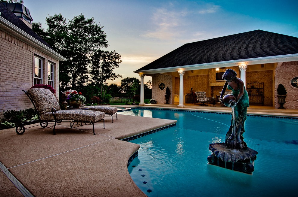 Imagen de casa de la piscina y piscina tradicional en forma de L en patio con losas de hormigón