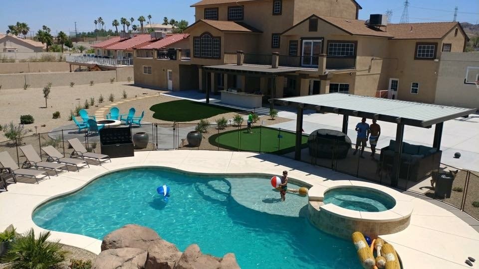 Foto di una piscina naturale stile americano personalizzata di medie dimensioni e dietro casa con un acquascivolo e pedane
