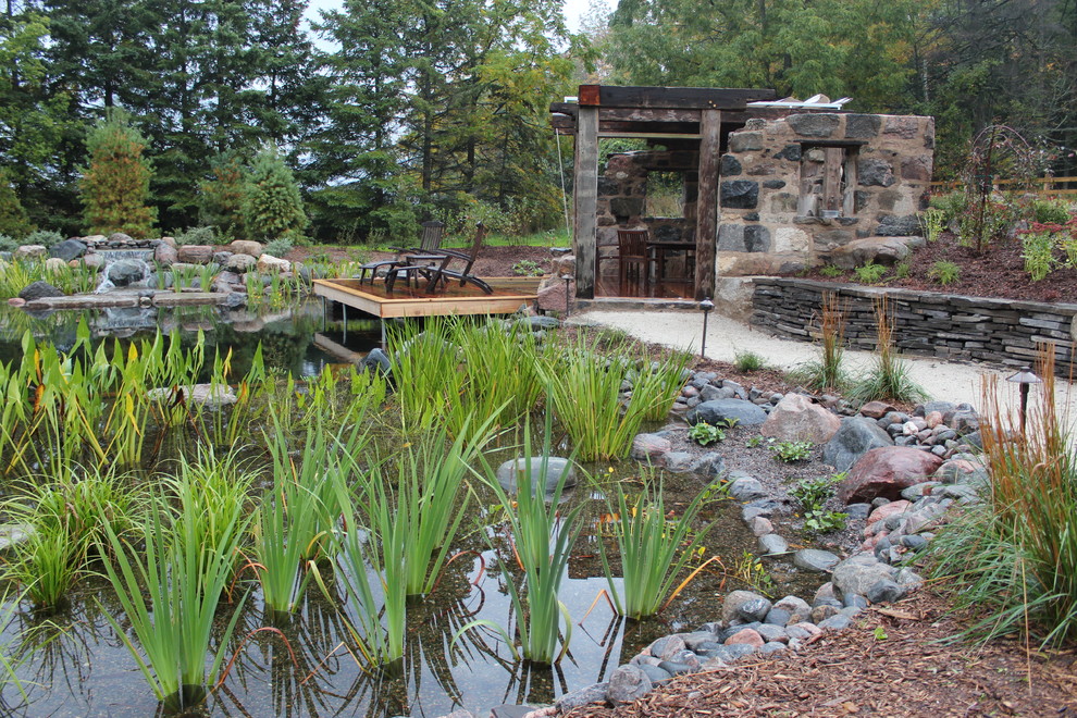 Idee per una piscina naturale stile rurale personalizzata di medie dimensioni e dietro casa con fontane e ghiaia