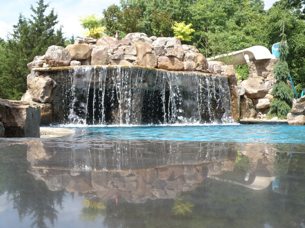 Inspiration for a large craftsman backyard custom-shaped pool fountain remodel in Kansas City