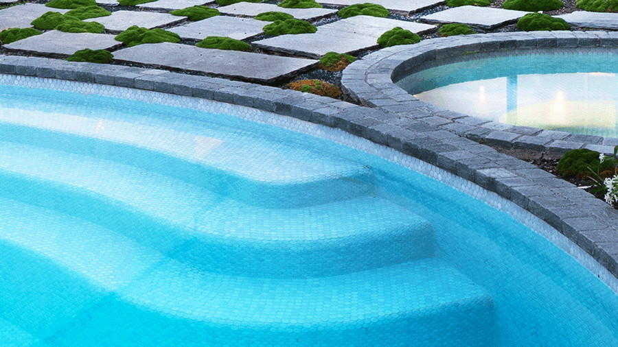 Esempio di una grande piscina minimalista rotonda davanti casa con paesaggistica bordo piscina e graniglia di granito