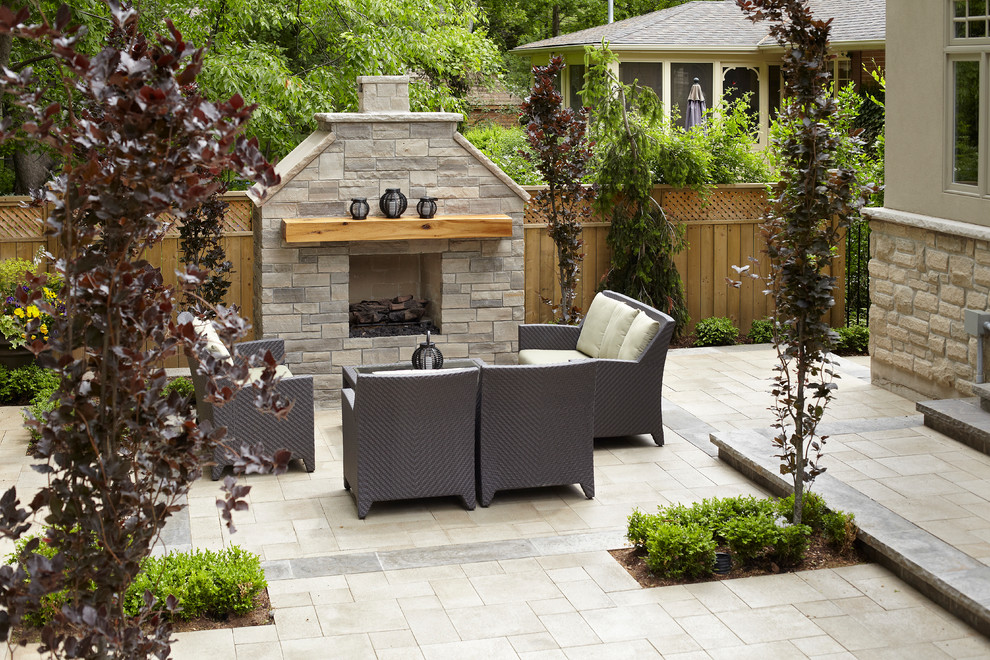 Example of a mid-sized trendy backyard concrete paver patio design in Toronto