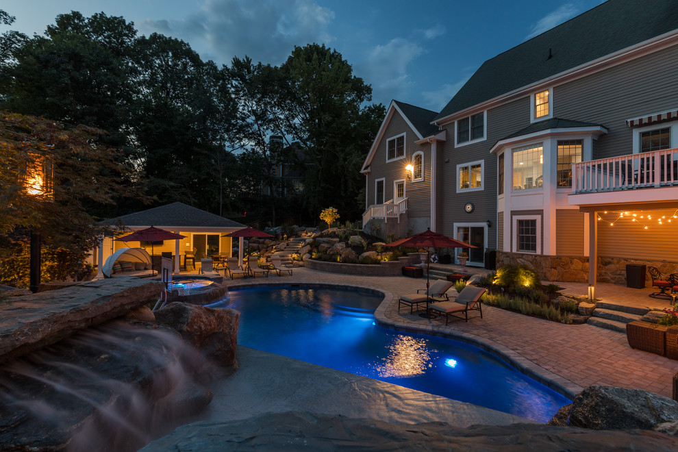 Mid-sized mountain style backyard brick and custom-shaped water slide photo in New York
