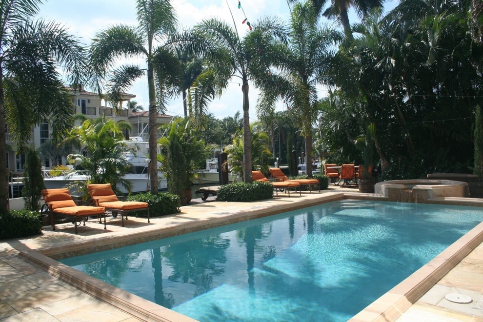 Hot tub - mid-sized traditional backyard stone and rectangular lap hot tub idea in Miami