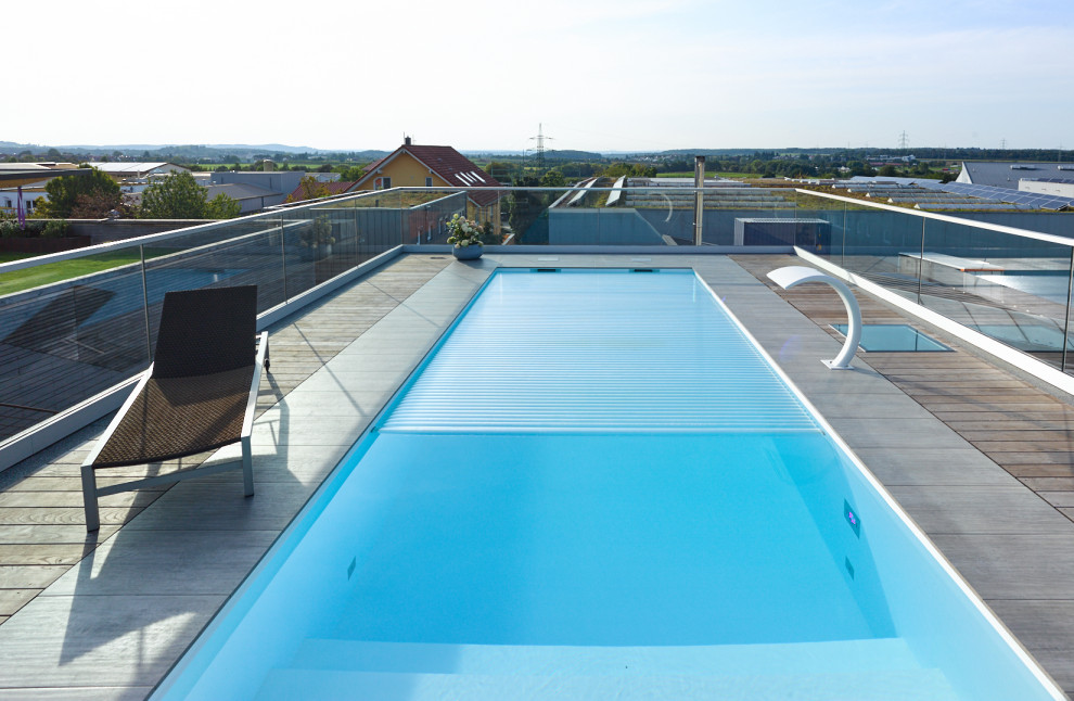Esempio di una piscina monocorsia minimal rettangolare di medie dimensioni e sul tetto con pedane