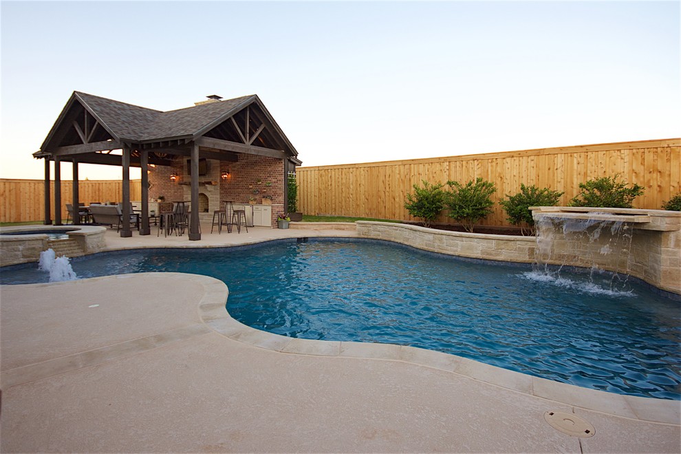 Inspiration for a large rustic backyard concrete and custom-shaped natural hot tub remodel in Austin