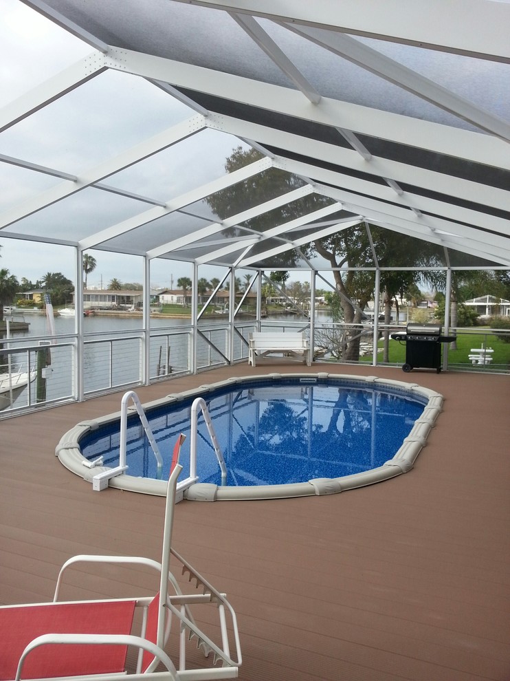 Design ideas for a medium sized world-inspired back round swimming pool in Tampa with decking.