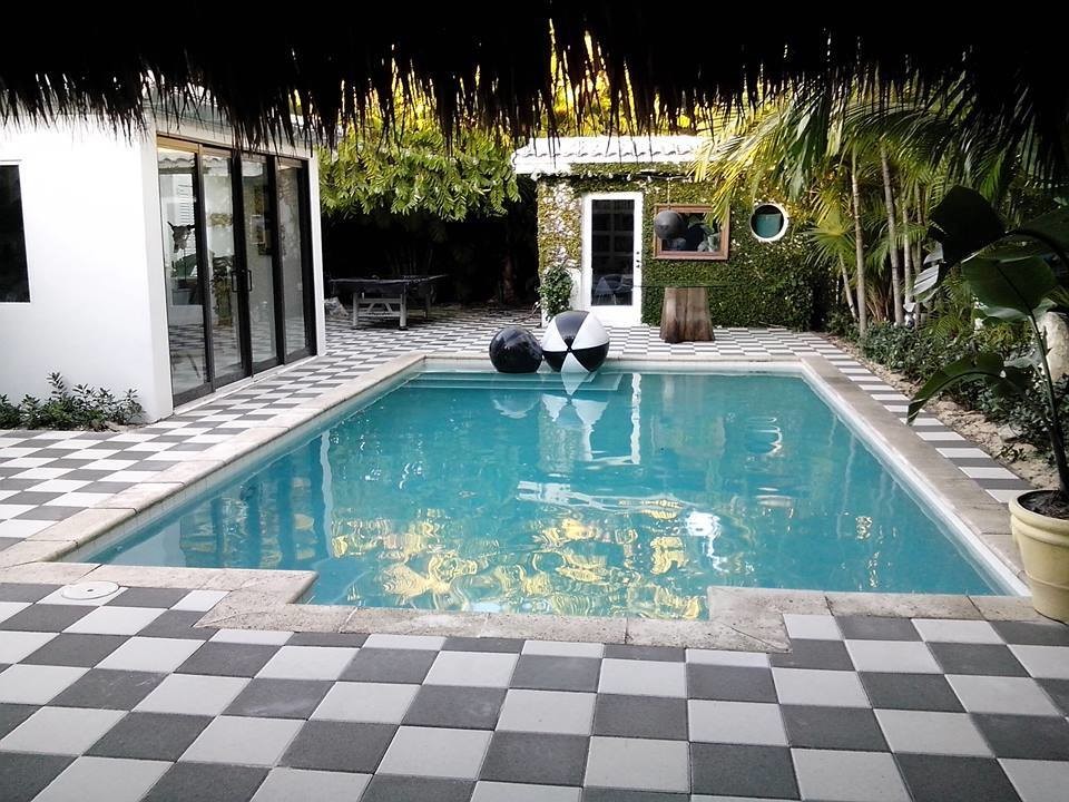 Imagen de casa de la piscina y piscina alargada clásica renovada de tamaño medio rectangular en patio trasero con adoquines de piedra natural