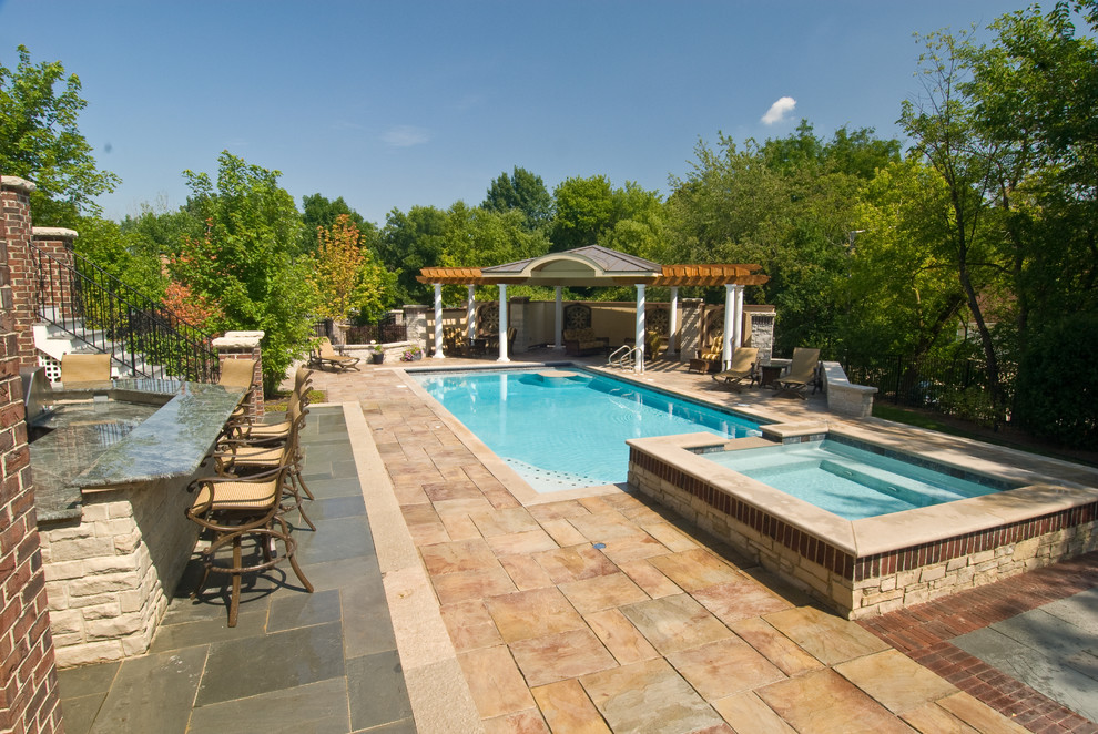 Pool - large traditional backyard stone and rectangular lap pool idea in Chicago