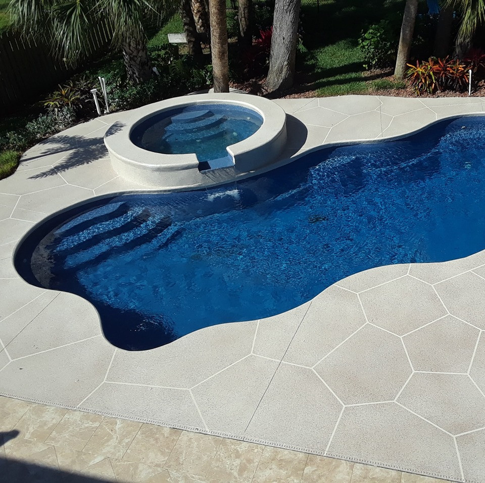 Photo of a medium sized world-inspired back swimming pool in Other with concrete slabs.
