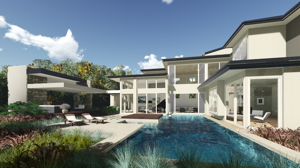 Diseño de piscina alargada contemporánea grande a medida en patio trasero con adoquines de piedra natural