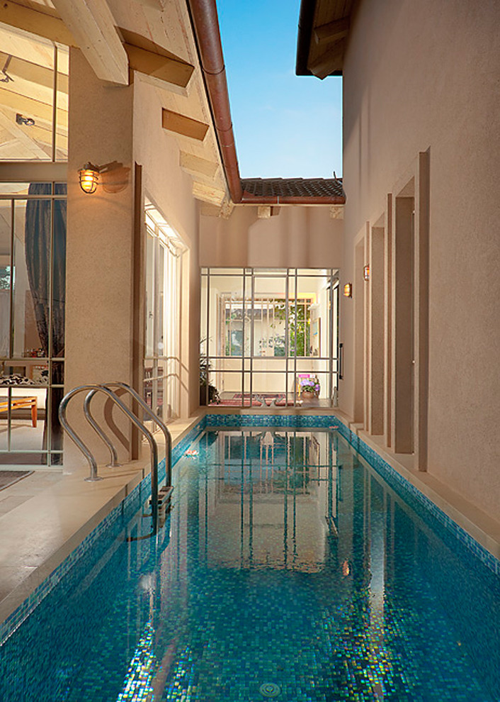Example of a trendy courtyard lap pool design in Other