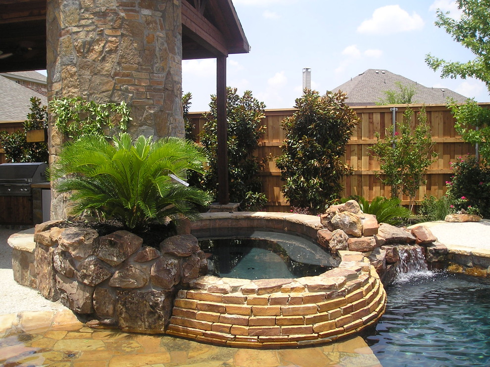 Large arts and crafts backyard concrete and custom-shaped natural hot tub photo in Dallas