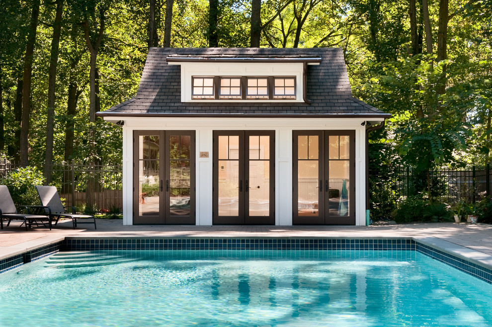 Design ideas for a classic rectangular swimming pool in Philadelphia with brick paving and a pool house.