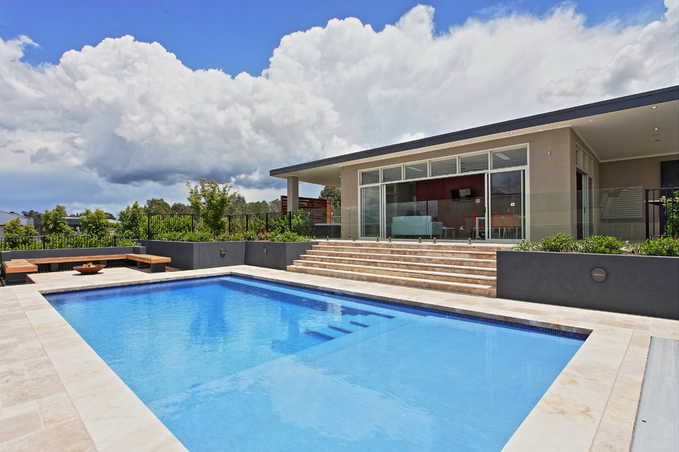 Huge trendy backyard stone and rectangular pool house photo in Sydney