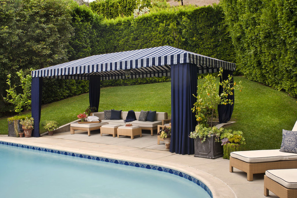 Inspiration for a transitional stamped concrete and round pool remodel in Los Angeles